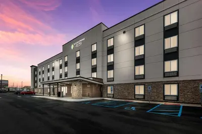 a rendering of the exterior of a hotel at WoodSpring Suites Linden in Linden