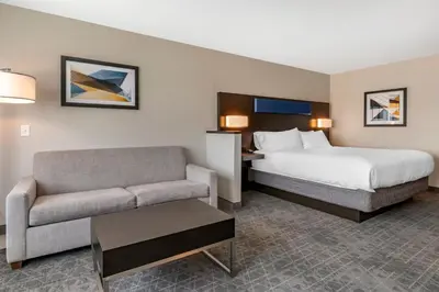 a hotel room with a bed and a couch at Holiday Inn Express & Suites - Lancaster - Mount Joy by IHG in Mount Joy