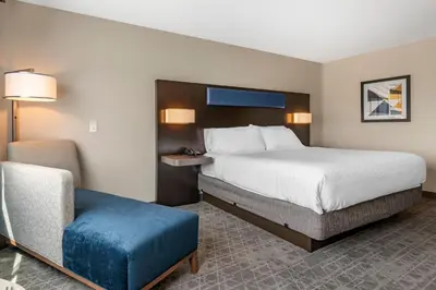 a hotel room with a bed and a chair at Holiday Inn Express & Suites - Lancaster - Mount Joy by IHG in Mount Joy