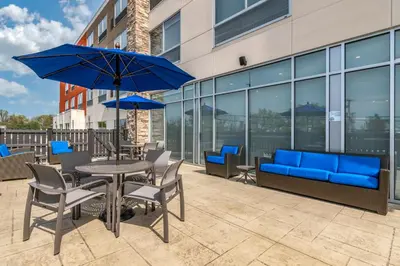 a patio with a table and chairs and a blue couch at Holiday Inn Express & Suites - Lancaster - Mount Joy by IHG in Mount Joy