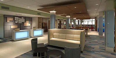 a lobby with two monitors and chairs and tables at Holiday Inn Express & Suites - Lancaster - Mount Joy by IHG in Mount Joy