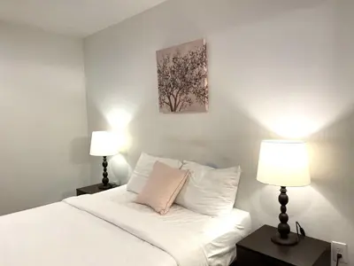 a bedroom with a white bed with two lamps at AF Stays - Philadelphia Convention Center in Philadelphia