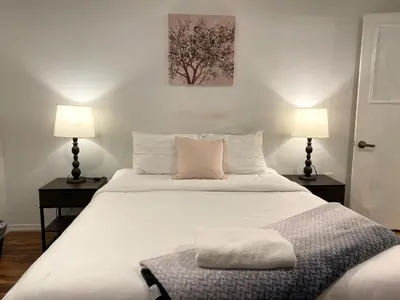 a bedroom with a large white bed with two lamps at AF Stays - Philadelphia Convention Center in Philadelphia