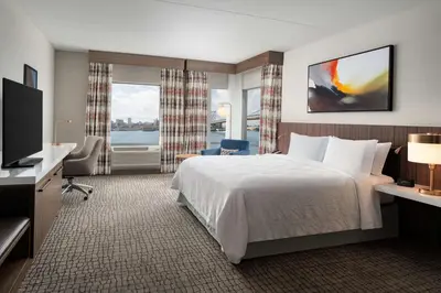 a hotel room with a bed and a television at Hilton Garden Inn Camden Waterfront Philadelphia in Camden