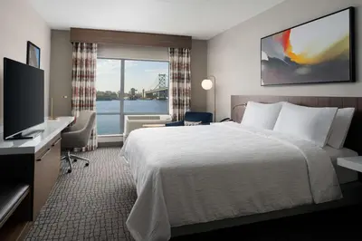 a hotel room with a bed and a television at Hilton Garden Inn Camden Waterfront Philadelphia in Camden