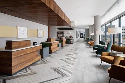 a lobby with couches and chairs in a building at Hilton Garden Inn Camden Waterfront Philadelphia in Camden