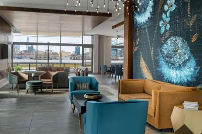 a lobby with couches and chairs and a table at Hilton Garden Inn Camden Waterfront Philadelphia in Camden