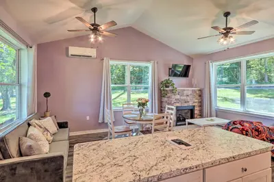 a living room with a couch and a table at Relax Fireside! Retreat 16 Mi to Camelback Resort in Saylorsburg