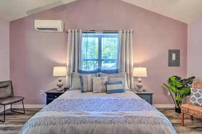 a bedroom with a large bed and a window at Relax Fireside! Retreat 16 Mi to Camelback Resort in Saylorsburg