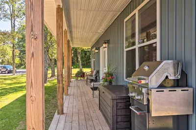 an outdoor patio with a grill on a house at Relax Fireside! Retreat 16 Mi to Camelback Resort in Saylorsburg