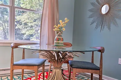 a glass table with chairs and a vase on it at 16 Mi to Ski Slopes! Creekside Poconos Cottage in Brodheadsville