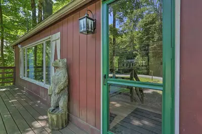 a bear statue on the side of a house at Quaint Lake Cottage with Pool and Beach Access! in Pocono Lake