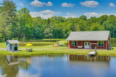a small cabin on the edge of a lake at Close to Slopes Lakeside Cottage in Pocono Mtns in Brodheadsville