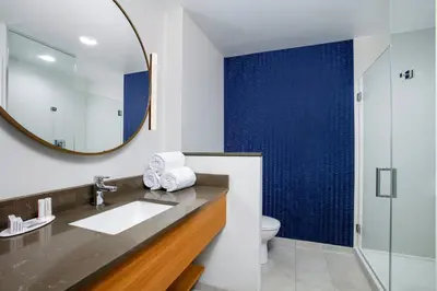 a bathroom with a sink and a mirror at Fairfield by Marriott Inn & Suites Harrisburg West/Mechanicsburg in Mechanicsburg