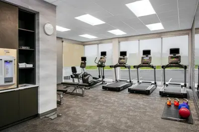 a gym with a row of treadmills and machines at Fairfield by Marriott Inn & Suites Harrisburg West/Mechanicsburg in Mechanicsburg