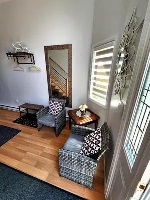a living room with chairs and a table and a mirror at Paradise in heart of Poconos FaSt InTeRnEt Close to All Attractions in Pocono Summit
