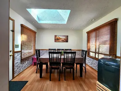 a dining room with a table and chairs and a skylight at Paradise in heart of Poconos FaSt InTeRnEt Close to All Attractions in Pocono Summit
