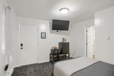 a bedroom with a bed and a tv on the wall at Halifax Inn in Halifax