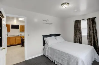 a bedroom with a bed and a kitchen at Halifax Inn in Halifax