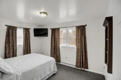 a bedroom with a bed and a window at Halifax Inn in Halifax