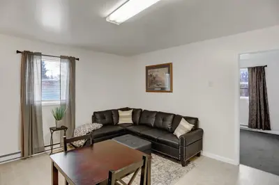 a living room with a leather couch and a table at Halifax Inn in Halifax