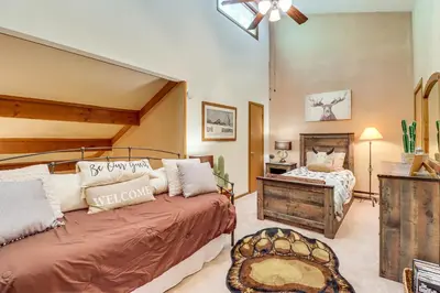 a bedroom with a large bed and a desk at Walk to Dining! Townhome 1 Mi to Big Boulder Mtn in Lake Harmony