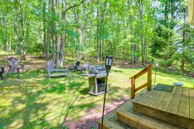 a backyard with a grill and chairs and trees at Walk to Dining! Townhome 1 Mi to Big Boulder Mtn in Lake Harmony