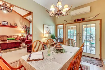 a dining room and living room with a table and chairs at Walk to Dining! Townhome 1 Mi to Big Boulder Mtn in Lake Harmony