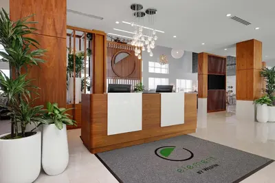 a lobby with a reception desk and potted plants at Element New York Wood Ridge in Wood-Ridge