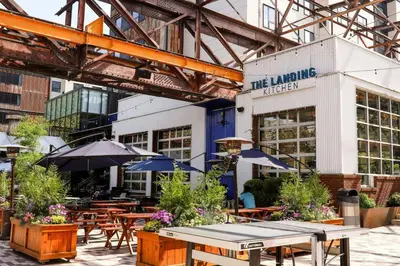 a restaurant with tables and umbrellas in front of a building at Residence Inn By Marriott Philadelphia Bala Cynwyd in Bala-Cynwyd
