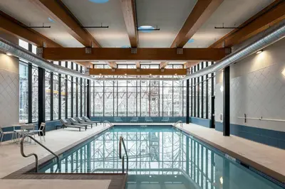 a pool in a building with windows and a swimming pool at Residence Inn By Marriott Philadelphia Bala Cynwyd in Bala-Cynwyd