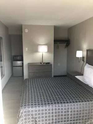 a bedroom with a bed with a lamp on it at Trolley Stop Motel, Media ,Near PHL Airport PA in Media