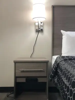 a lamp on a night stand next to a bed at Trolley Stop Motel, Media ,Near PHL Airport PA in Media