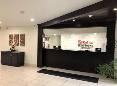 a restaurant with a counter with a sign on it at HomeTowne Studios by Red Roof Bordentown - McGuire AFB in Bordentown