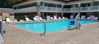 a swimming pool in front of a hotel at HomeTowne Studios by Red Roof Bordentown - McGuire AFB in Bordentown
