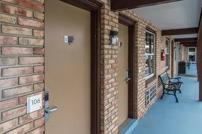 an open door to a brick building with a bench at Sunrise Inn Hershey in Hershey