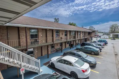 a building with cars parked in a parking lot at Sunrise Inn Hershey in Hershey