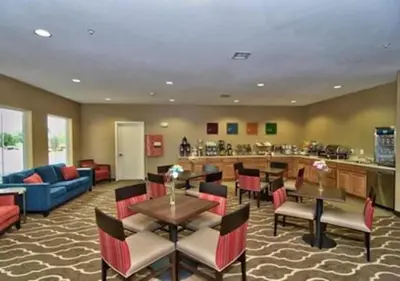 a restaurant with tables and chairs and a bar at Comfort Inn Apalachin - Binghamton W Route 17 in Apalachin