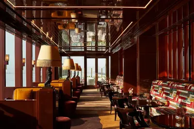 a dining room with tables and chairs and windows at Casa Cipriani New York in New York