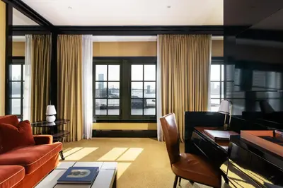 a living room with a couch and a desk at Casa Cipriani New York in New York