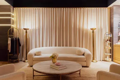 a living room with a couch and a table at Casa Cipriani New York in New York