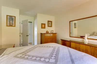 a bedroom with a bed and a large mirror at Ski, Swim and Relax Waterfront Haven on Pines Lake! in Pocono Lake