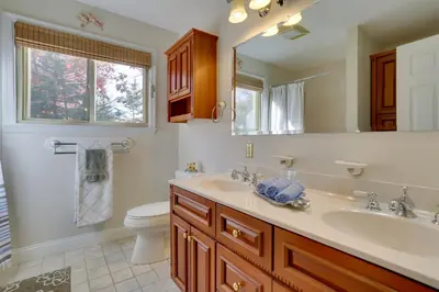 a bathroom with a sink and a toilet at Ski, Swim and Relax Waterfront Haven on Pines Lake! in Pocono Lake