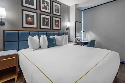 a large white bed in a hotel room at The Draper New York, Tapestry Collection by Hilton in New York
