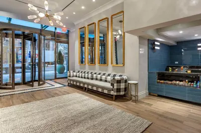 a waiting room with a bench in a store at The Draper New York, Tapestry Collection by Hilton in New York
