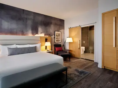 a hotel room with a bed and a chair at Live! Casino & Hotel - Philadelphia in Philadelphia