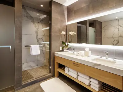 a bathroom with a sink and a shower and a mirror at Live! Casino & Hotel - Philadelphia in Philadelphia