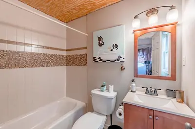 a bathroom with a toilet and a sink and a tub at Luxurious house with largest hot tub & perfect retreat! in Lake Harmony