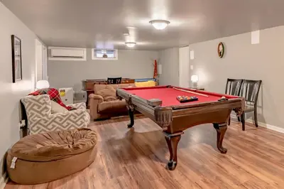 a living room with a pool table and a couch at Luxurious house with largest hot tub & perfect retreat! in Lake Harmony