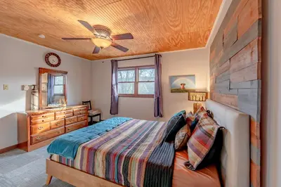 a bedroom with a bed and a ceiling fan at Luxurious house with largest hot tub & perfect retreat! in Lake Harmony